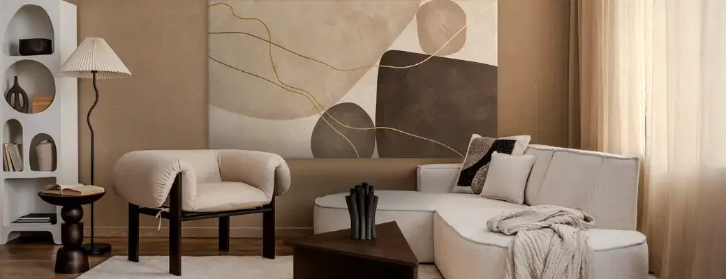 A Modern Living Room in Earthy Tones with a Large Abstract Painting A minimalist interior visualization depicting a large painting in a black frame hanging on a beige wall with decorative stucco. The painting depicts wildflowers.